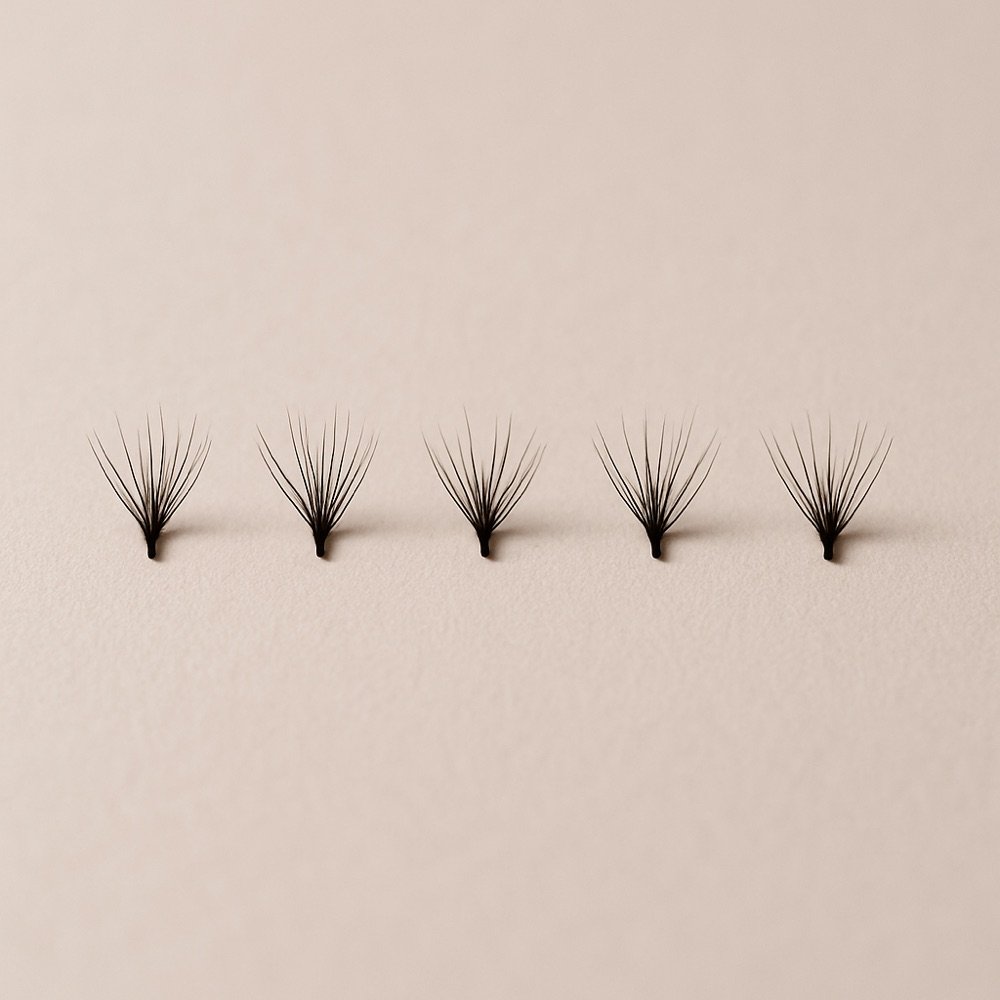 AI-generated editorial photograph of several individual lash clusters spaced in a row